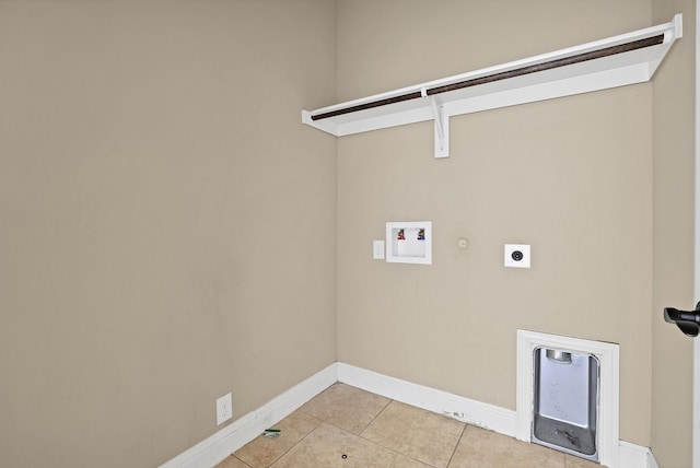 clothes washing area featuring gas dryer hookup, washer hookup, light tile patterned flooring, and electric dryer hookup