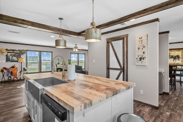 kitchen with dark wood-style floors, butcher block counters, beam ceiling, and dishwasher