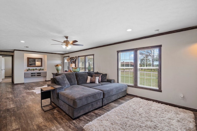 living area with ceiling fan, recessed lighting, dark wood-type flooring, baseboards, and crown molding