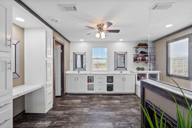 bar featuring dark wood-style floors, visible vents, built in desk, and a ceiling fan