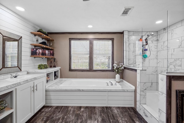 full bath with a garden tub, visible vents, vanity, wood finished floors, and a walk in shower