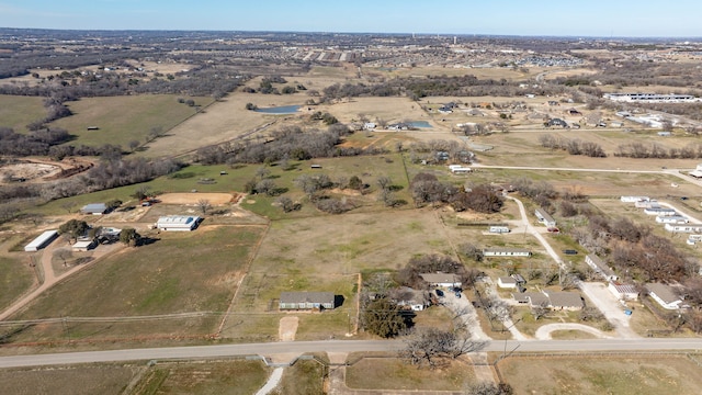 birds eye view of property with a rural view