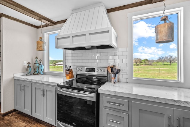 kitchen featuring tasteful backsplash, custom exhaust hood, gray cabinets, and stainless steel range with electric stovetop