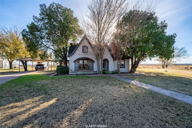 view of front of house with a carport and a front lawn