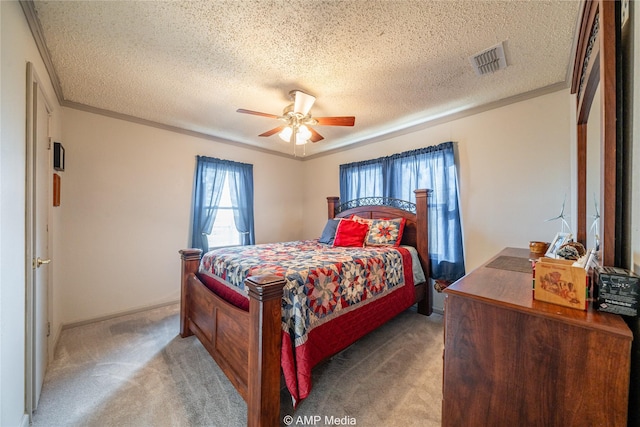 bedroom featuring light carpet, a textured ceiling, ceiling fan, and crown molding