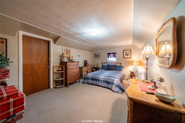 bedroom with carpet floors and vaulted ceiling