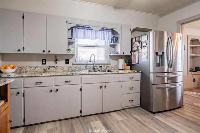 kitchen featuring light hardwood / wood-style floors, sink, white cabinetry, and stainless steel refrigerator with ice dispenser