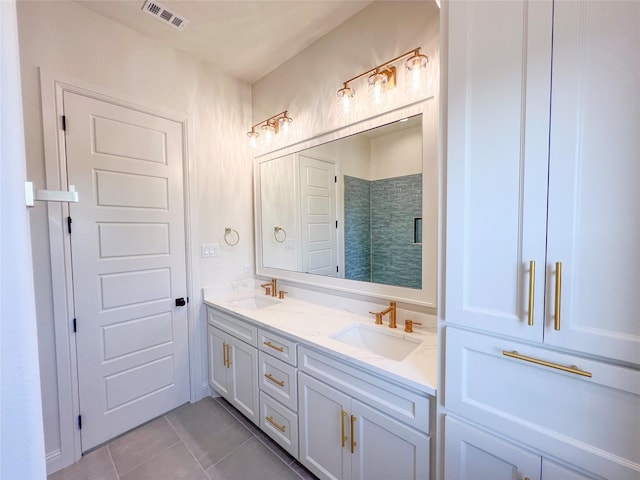 bathroom with tile patterned flooring, a shower with door, and vanity