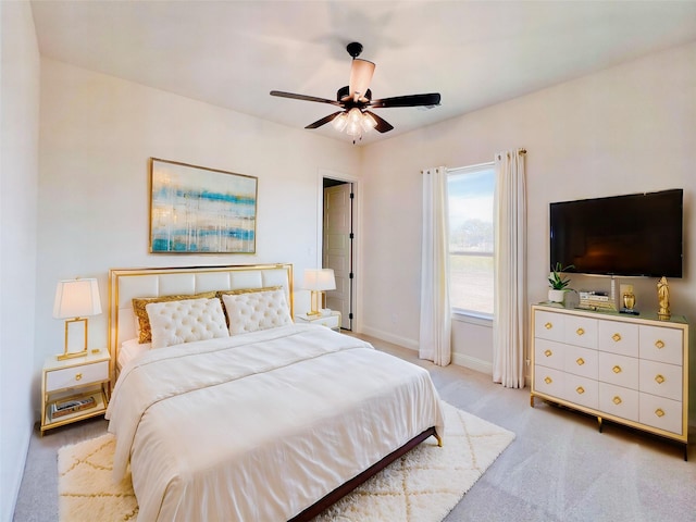 bedroom featuring light carpet and ceiling fan