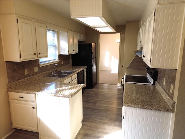 kitchen featuring stove, dark hardwood / wood-style flooring, sink, dishwasher, and white cabinetry