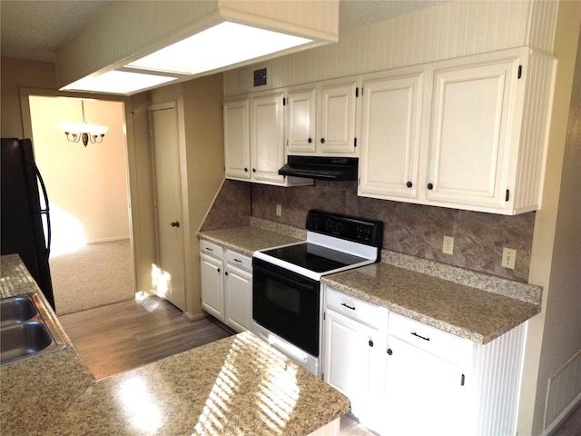 kitchen with white cabinetry, electric range, an inviting chandelier, black fridge, and exhaust hood