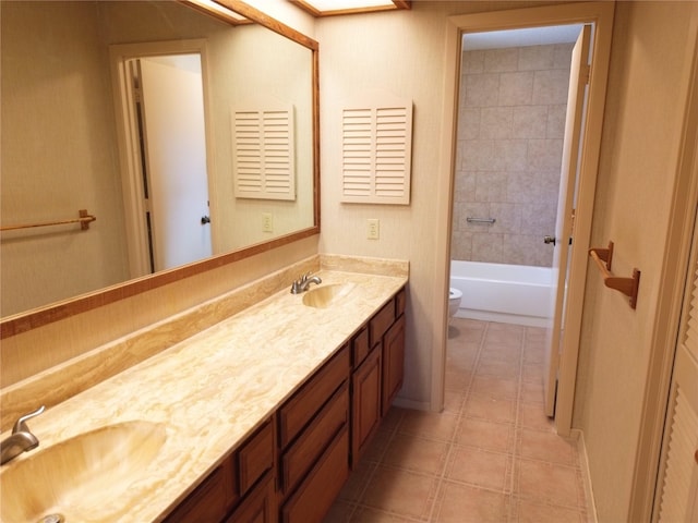 full bathroom featuring vanity, toilet, and tiled shower / bath combo