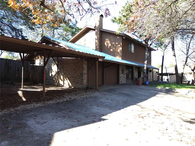 rear view of property with a carport