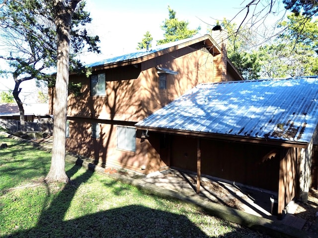 view of side of home with a lawn