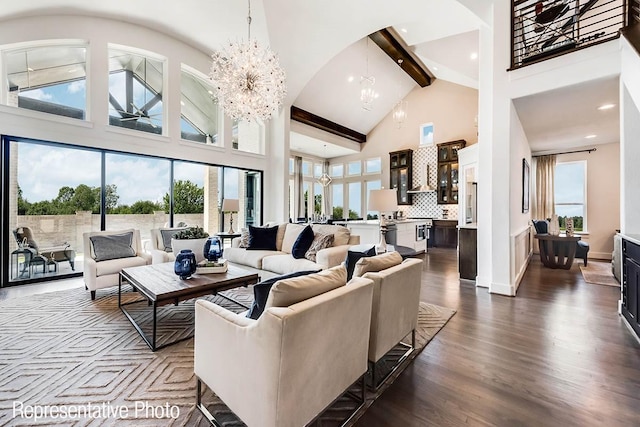 living room featuring a notable chandelier, beam ceiling, plenty of natural light, and high vaulted ceiling