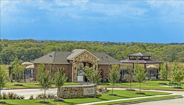 exterior space with a gazebo and a front yard