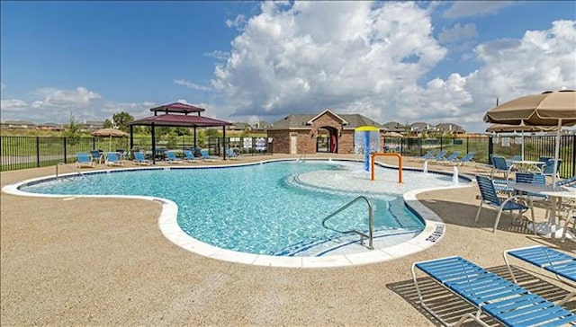 view of swimming pool with a gazebo, a patio, and pool water feature