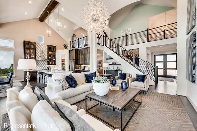 living room featuring french doors, an inviting chandelier, high vaulted ceiling, beamed ceiling, and light hardwood / wood-style floors