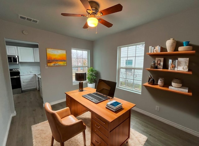 office featuring dark hardwood / wood-style floors and ceiling fan