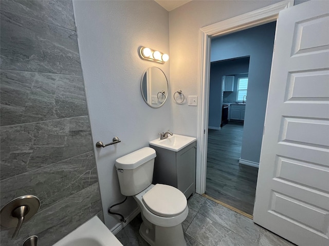 bathroom featuring vanity, toilet, and a bath