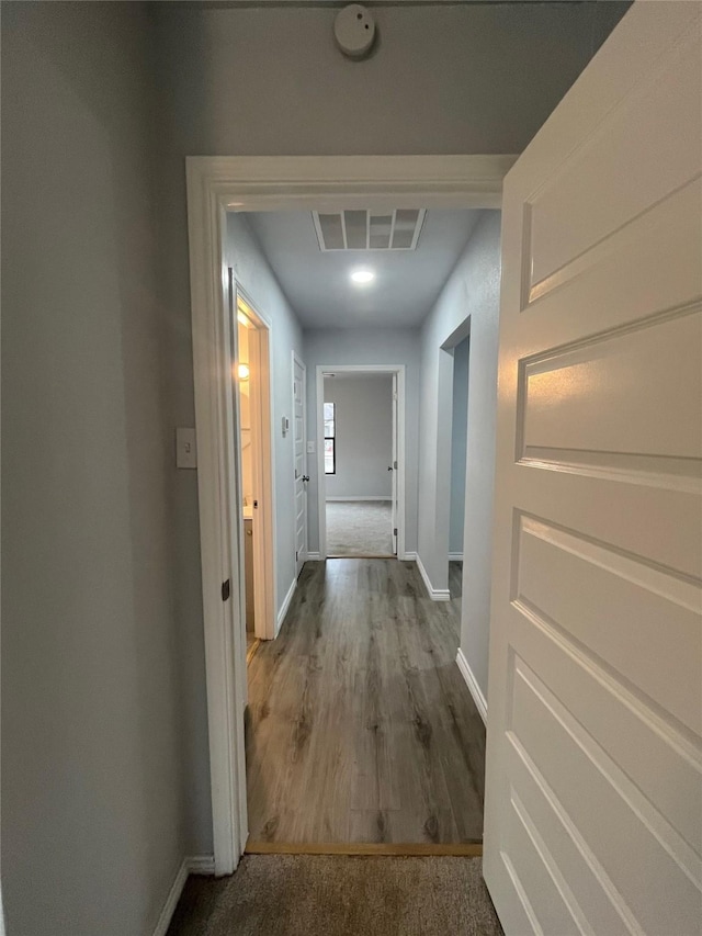 corridor with wood-type flooring