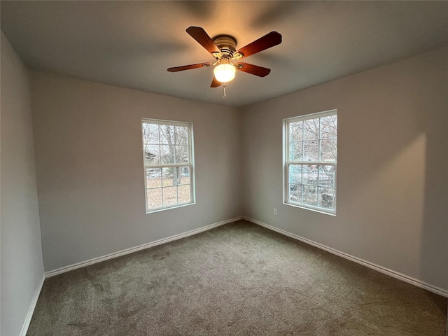 carpeted spare room with ceiling fan