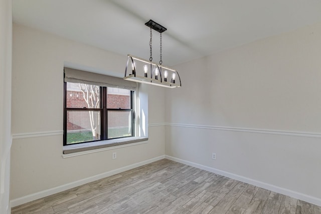 unfurnished dining area featuring light wood-type flooring