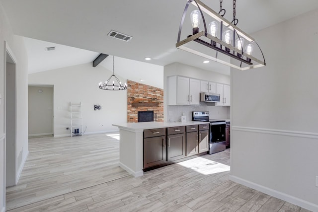 kitchen with lofted ceiling with beams, light hardwood / wood-style flooring, a notable chandelier, white cabinetry, and stainless steel appliances