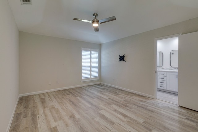 empty room with ceiling fan and light hardwood / wood-style flooring