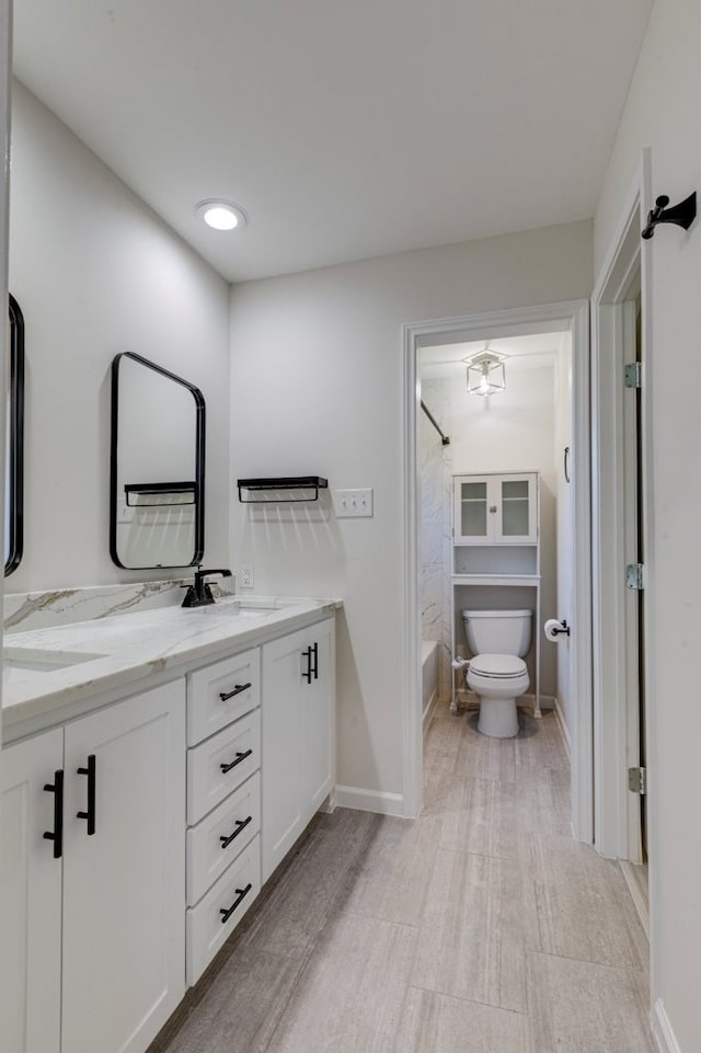 full bathroom featuring vanity, toilet, and tub / shower combination