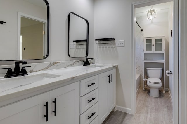 full bathroom with vanity, shower / bathtub combination, toilet, and wood-type flooring