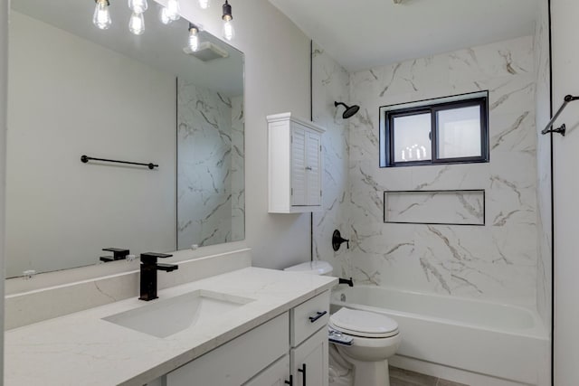 full bathroom with vanity, tiled shower / bath combo, and toilet