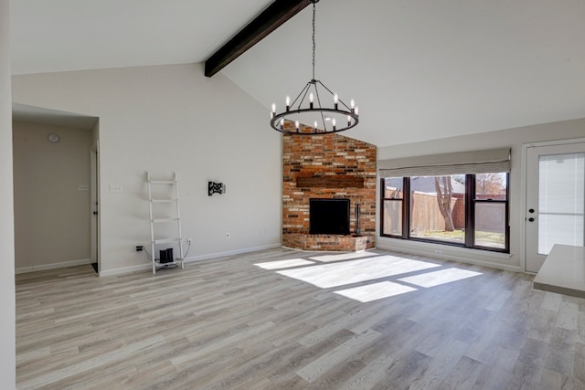 unfurnished living room featuring high vaulted ceiling, an inviting chandelier, light hardwood / wood-style floors, a fireplace, and beam ceiling