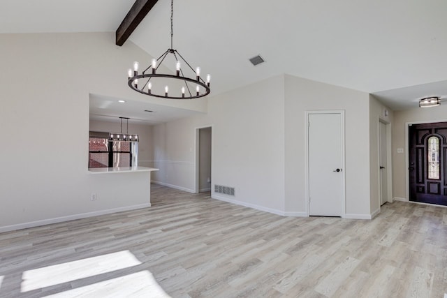 interior space featuring vaulted ceiling with beams, light hardwood / wood-style floors, and a chandelier