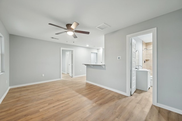 unfurnished living room with light wood-type flooring and ceiling fan