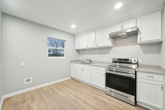 kitchen featuring light hardwood / wood-style floors, white cabinetry, stainless steel range with electric cooktop, and sink