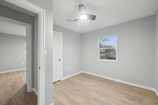 spare room featuring light hardwood / wood-style floors and ceiling fan