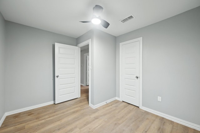 unfurnished bedroom featuring a closet, light hardwood / wood-style flooring, and ceiling fan