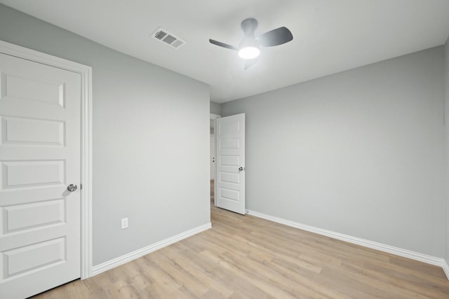 empty room featuring light hardwood / wood-style flooring and ceiling fan