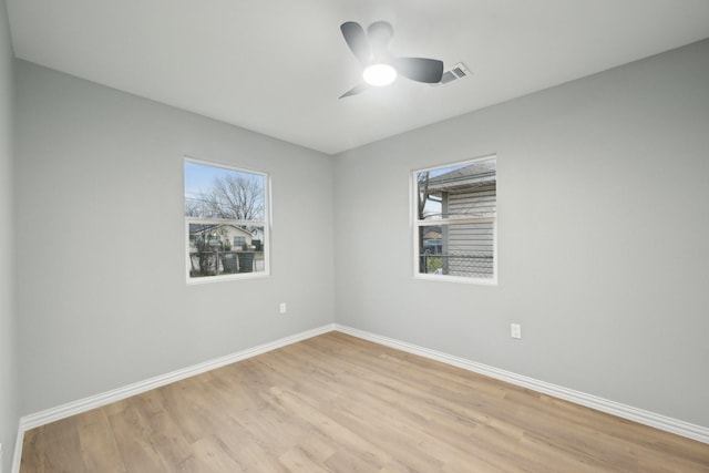 empty room featuring ceiling fan and light hardwood / wood-style flooring