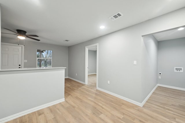 spare room featuring ceiling fan and light hardwood / wood-style flooring