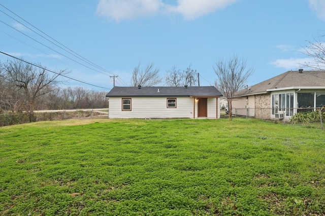 back of house with a lawn