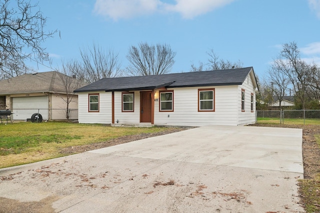 ranch-style house with a garage and a front lawn