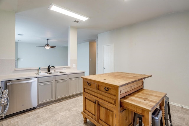 kitchen with gray cabinets, stainless steel dishwasher, ceiling fan, and sink