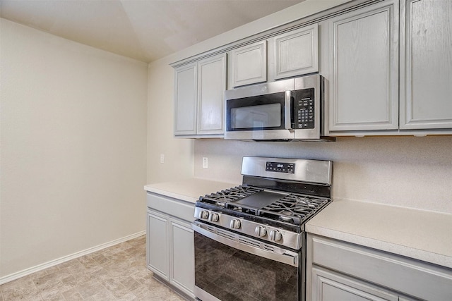 kitchen featuring gray cabinets and appliances with stainless steel finishes