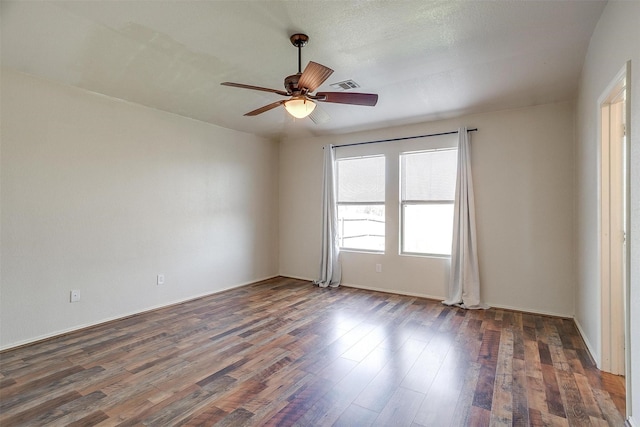 unfurnished room featuring ceiling fan and dark hardwood / wood-style floors