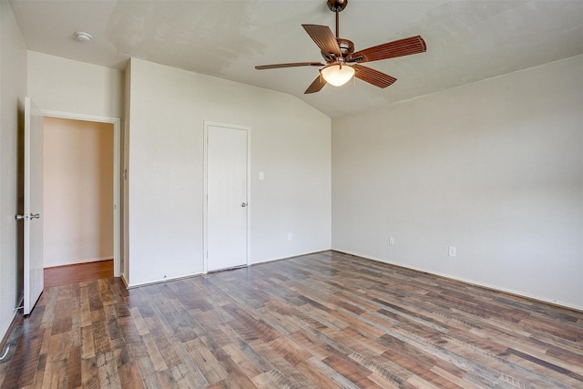 unfurnished bedroom featuring ceiling fan, a closet, wood-type flooring, and vaulted ceiling