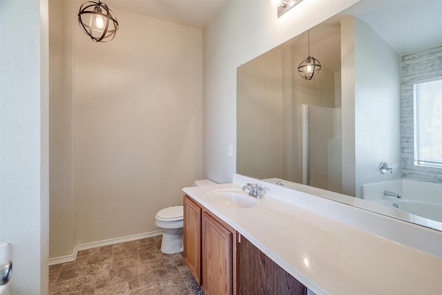 bathroom with vanity, a bathtub, and toilet