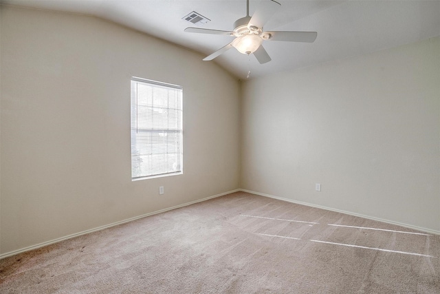 carpeted empty room with ceiling fan and lofted ceiling