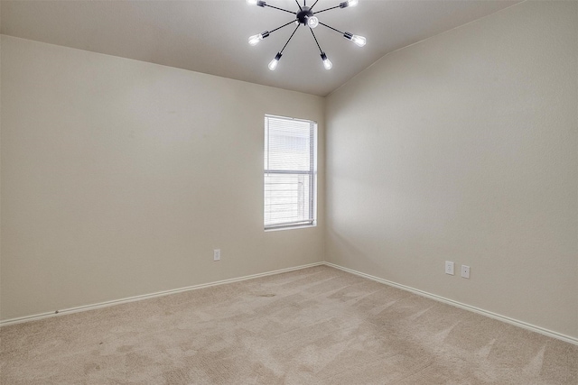 spare room featuring a chandelier, light colored carpet, and lofted ceiling